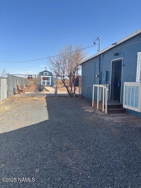 view of yard with central AC unit, fence, and a gate