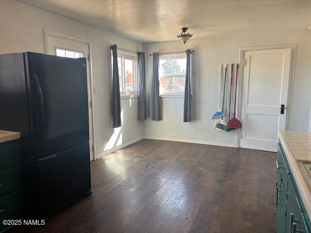 dining room featuring dark wood-type flooring and baseboards