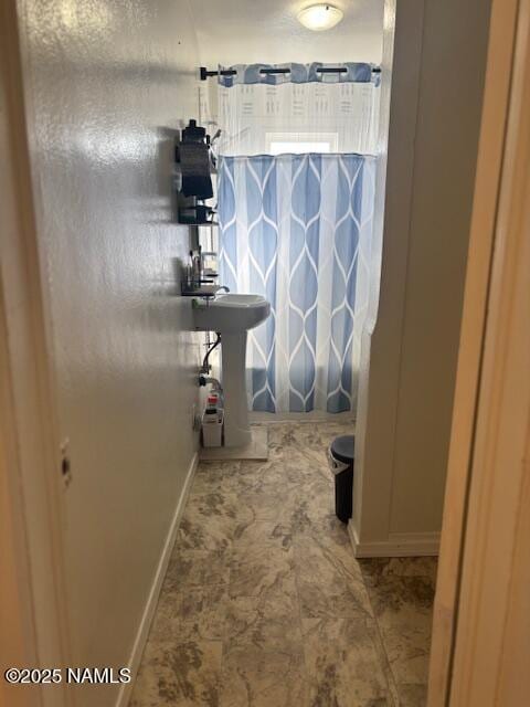 bathroom featuring baseboards