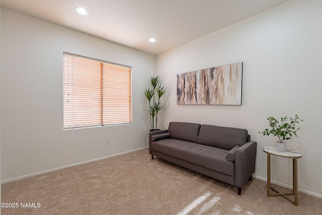 sitting room featuring light colored carpet