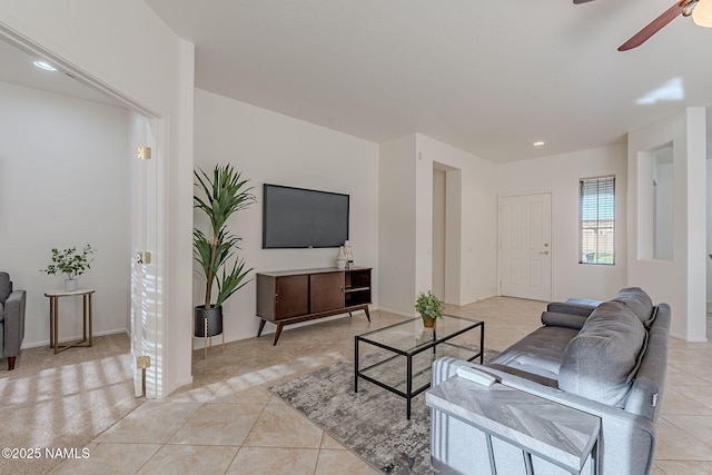 living room featuring light tile patterned flooring and ceiling fan