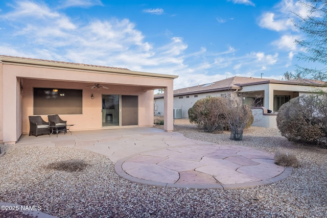 back of house with ceiling fan and a patio area