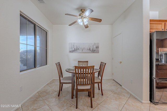 dining room featuring ceiling fan and light tile patterned floors