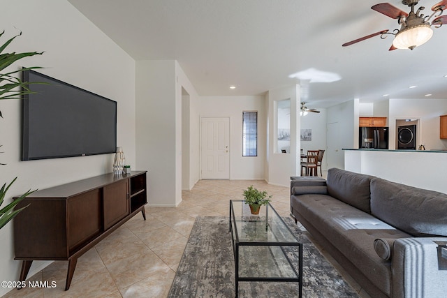 tiled living room featuring washer / clothes dryer and ceiling fan