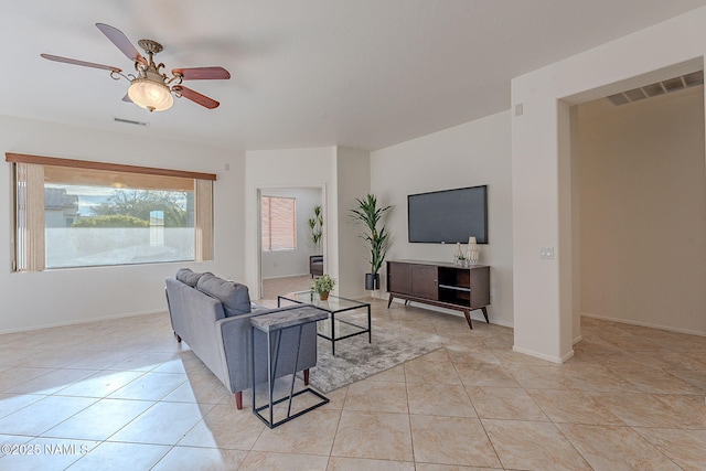 tiled living room with ceiling fan