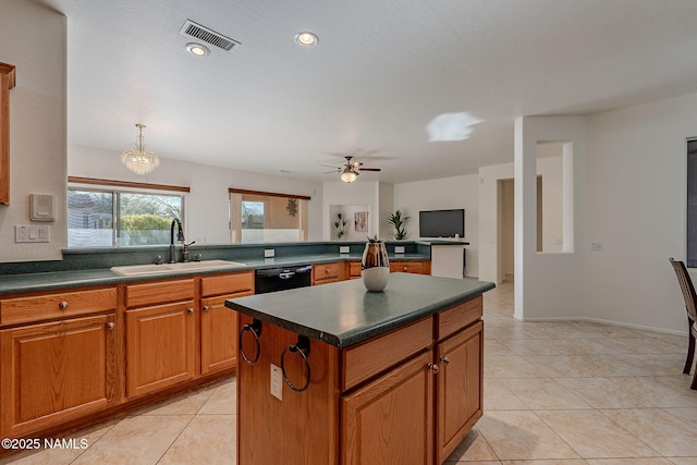 kitchen featuring sink, light tile patterned flooring, dishwasher, and a kitchen island