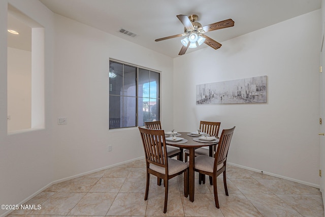 tiled dining room with ceiling fan