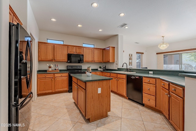 kitchen featuring light tile patterned flooring, sink, a kitchen island, pendant lighting, and black appliances