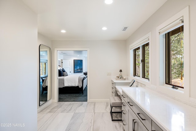 1451 N Mariposa Rd, Flagstaff, AZ 86004 - ensuite bathroom with marble look tile flooring, recessed lighting, baseboards, and vanity