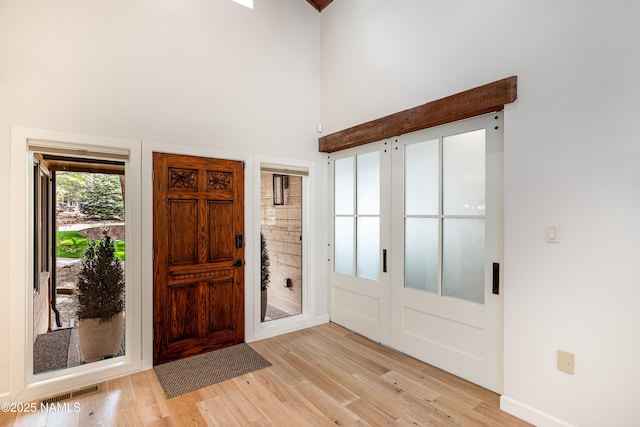 1451 N Mariposa Rd, Flagstaff, AZ 86004 - entryway with a high ceiling, light wood-style floors, and baseboards