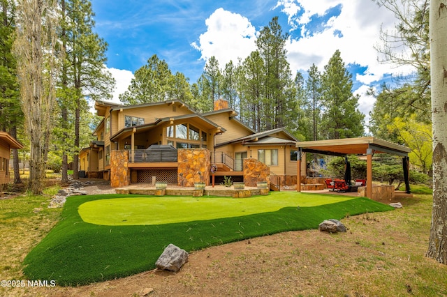 1451 N Mariposa Rd, Flagstaff, AZ 86004 - rear view of property with a chimney, a yard, and a wooden deck