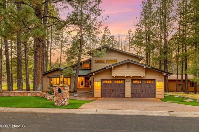 1451 N Mariposa Rd, Flagstaff, AZ 86004 - view of front of property with driveway, an attached garage, and a front lawn