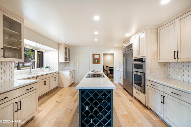 1451 N Mariposa Rd, Flagstaff, AZ 86004 - kitchen featuring a sink, appliances with stainless steel finishes, a kitchen island, tasteful backsplash, and light stone counters