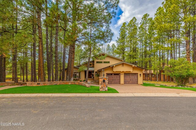 1451 N Mariposa Rd, Flagstaff, AZ 86004 - view of front of home with an attached garage, driveway, and a front yard