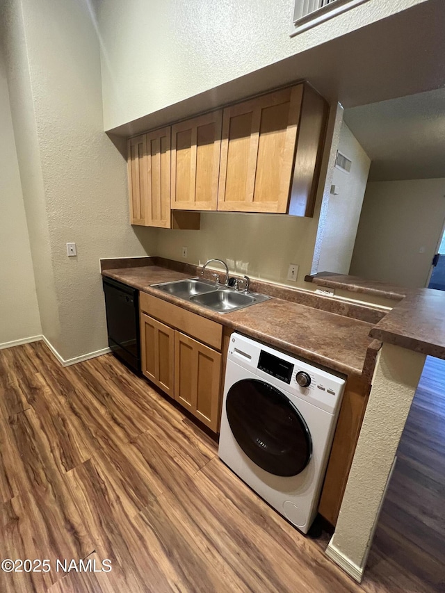 1185 W University Dr Unit 15-222, Flagstaff, AZ 86001 - kitchen with washer / clothes dryer, black dishwasher, dark wood-style flooring, dark countertops, and a textured wall