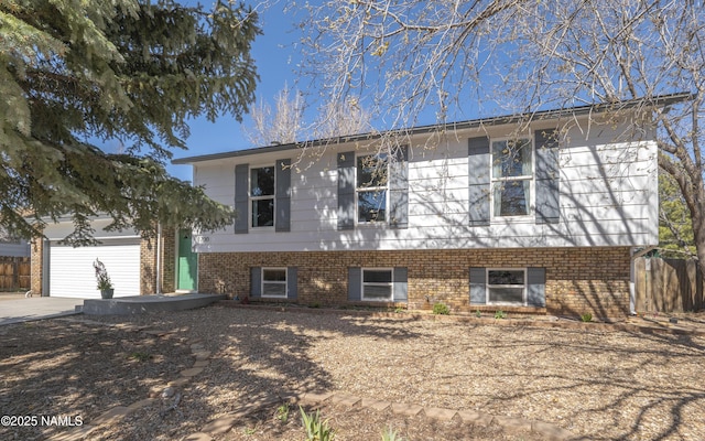 1700 N Foxglenn St, Flagstaff, AZ 86004 - view of front facade featuring fence, an attached garage, driveway, and brick siding
