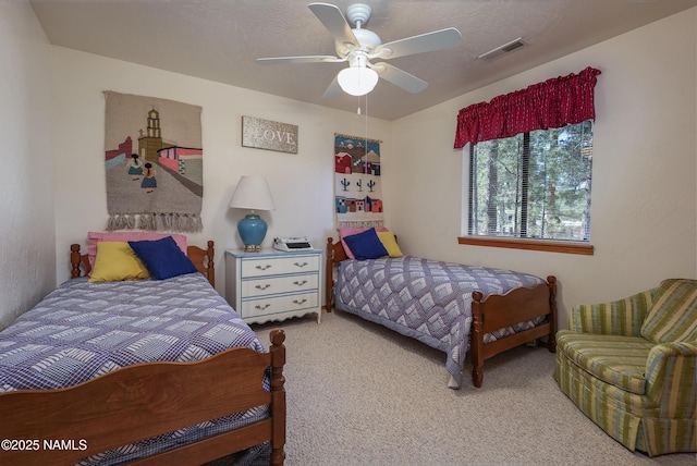 carpeted bedroom with ceiling fan and visible vents