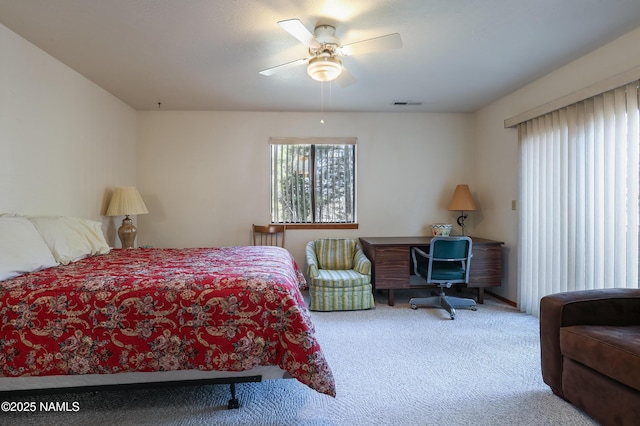 carpeted bedroom featuring visible vents and a ceiling fan