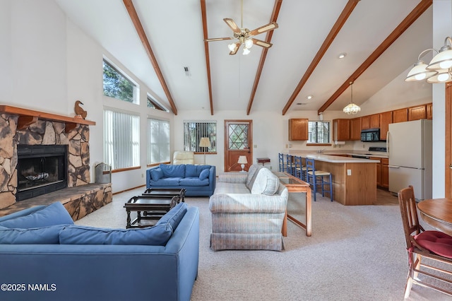 living area featuring high vaulted ceiling, light carpet, and beam ceiling