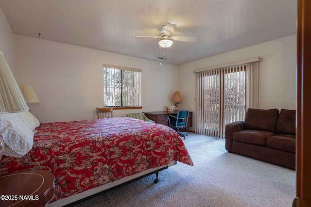bedroom featuring ceiling fan, multiple windows, carpet, and access to outside