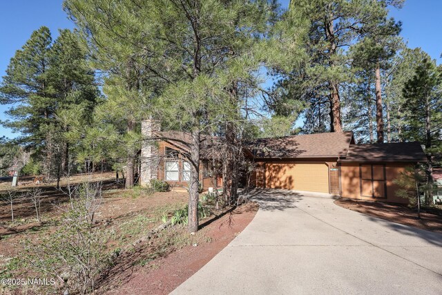 view of front of house with a garage and concrete driveway