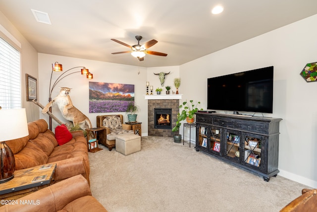 living room with ceiling fan, carpet flooring, and a brick fireplace