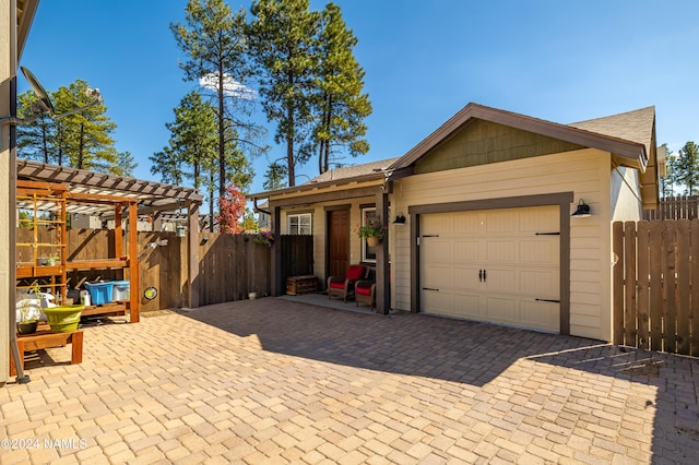 ranch-style house featuring a garage and a pergola