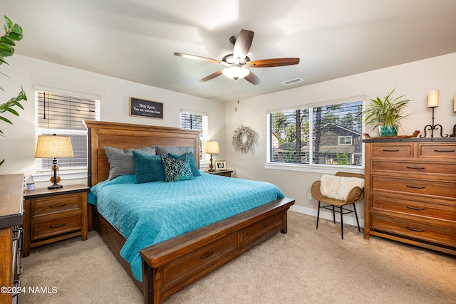 bedroom featuring light colored carpet and ceiling fan