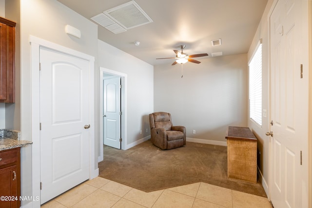 sitting room with light colored carpet and ceiling fan