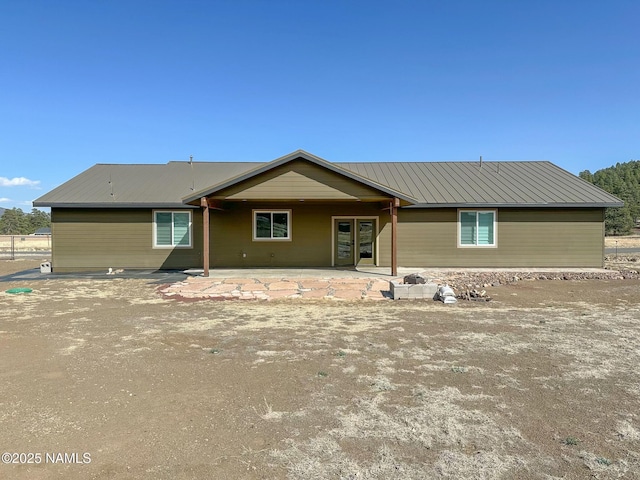 view of front facade with metal roof and a patio