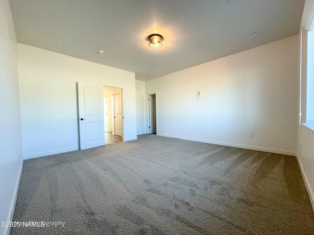 unfurnished bedroom with carpet flooring and baseboards