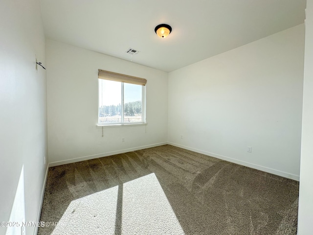 carpeted empty room featuring baseboards and visible vents