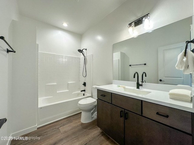 bathroom with vanity, bathing tub / shower combination, toilet, and wood finished floors