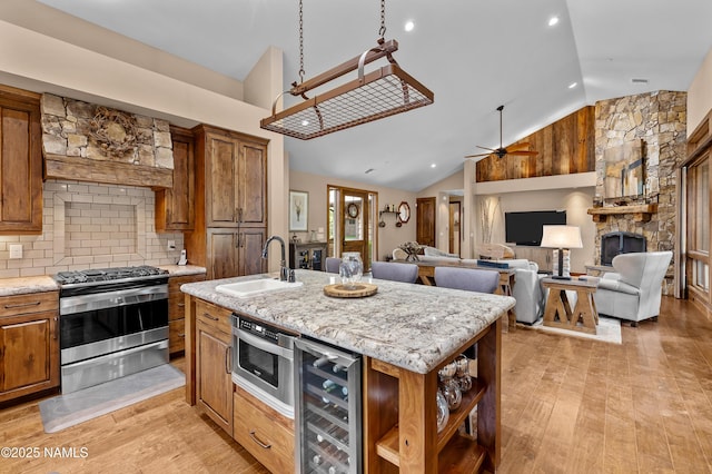 2047 E Del Rae Dr Unit 163, Flagstaff, AZ 86005 - kitchen featuring gas stove, wine cooler, lofted ceiling, brown cabinets, and light wood-type flooring
