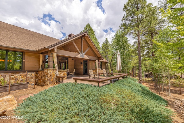 2047 E Del Rae Dr Unit 163, Flagstaff, AZ 86005 - back of property featuring a wooden deck, a shingled roof, and a chimney