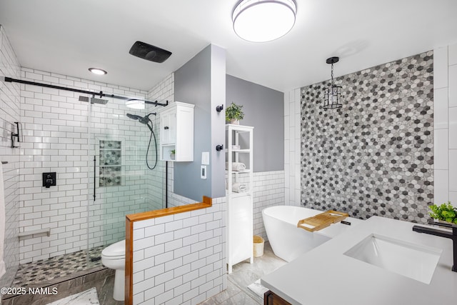 full bath with toilet, tile walls, a soaking tub, a shower stall, and vanity