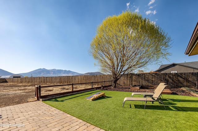 view of yard featuring a mountain view and a fenced backyard