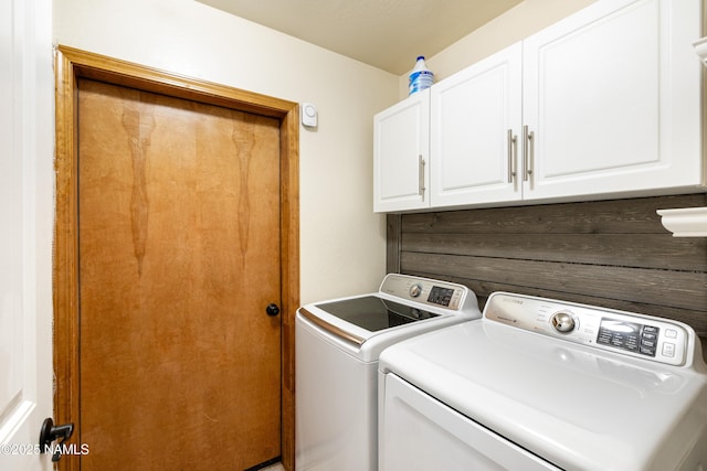 laundry room featuring cabinet space and washer and clothes dryer