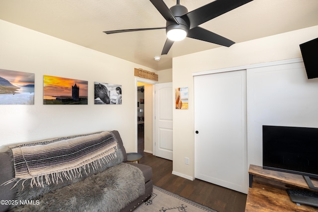 interior space with wood finished floors, ceiling fan, a closet, and baseboards