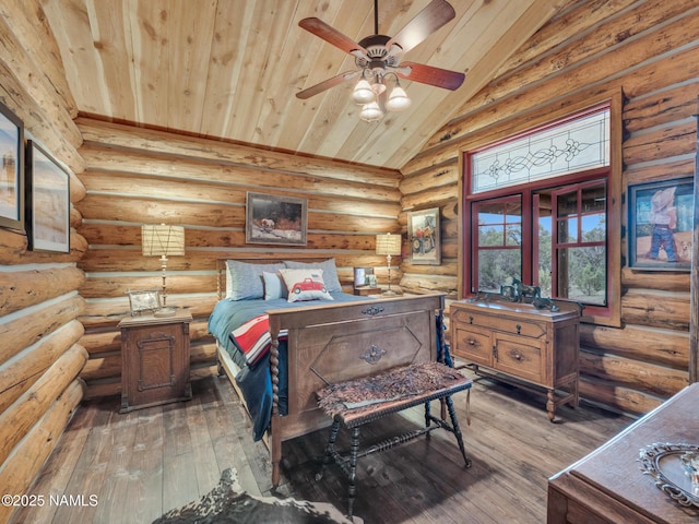 bedroom with lofted ceiling, wood ceiling, log walls, ceiling fan, and hardwood / wood-style flooring