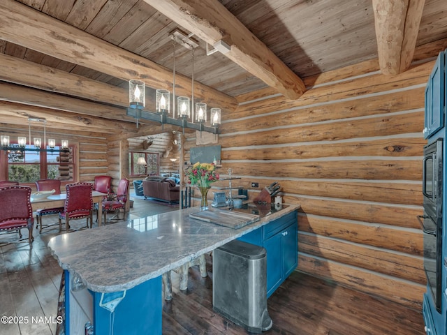 kitchen with beamed ceiling, log walls, wooden ceiling, hanging light fixtures, and blue cabinets