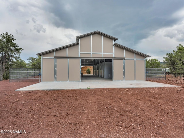 rear view of house featuring an outbuilding