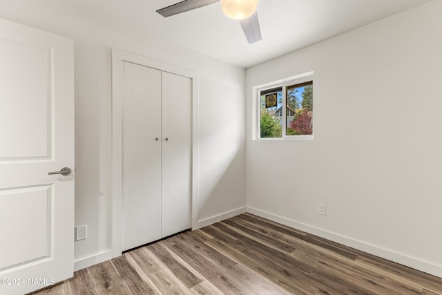 1024 E Hillcrest Dr, Flagstaff, AZ 86004 - unfurnished bedroom with wood finished floors, a closet, baseboards, and a ceiling fan