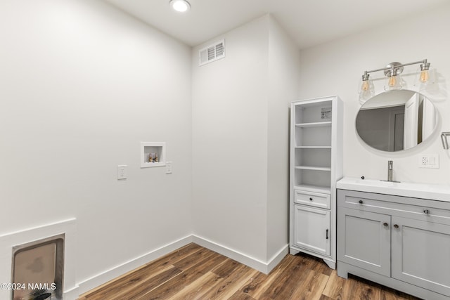 1024 E Hillcrest Dr, Flagstaff, AZ 86004 - laundry room with cabinet space, wood finished floors, recessed lighting, baseboards, and washer hookup