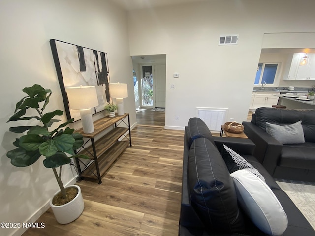 1024 E Hillcrest Dr, Flagstaff, AZ 86004 - living room with wood finished floors, baseboards, and a towering ceiling