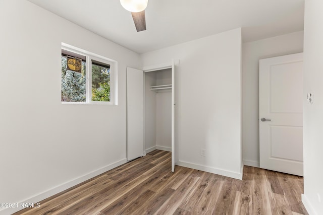 1024 E Hillcrest Dr, Flagstaff, AZ 86004 - unfurnished bedroom featuring wood finished floors, a closet, baseboards, and a ceiling fan