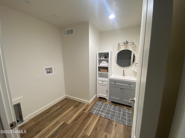 1024 E Hillcrest Dr, Flagstaff, AZ 86004 - bathroom with wood finished floors, vanity, and baseboards