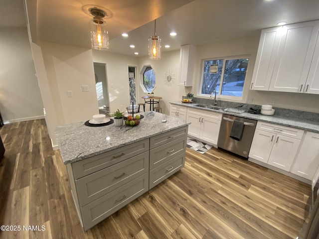 1024 E Hillcrest Dr, Flagstaff, AZ 86004 - kitchen with stainless steel dishwasher, white cabinetry, dark wood-style flooring, recessed lighting, and light stone counters
