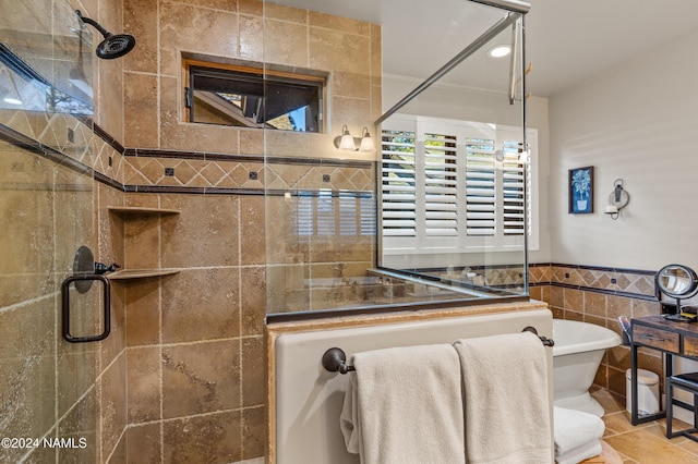 bathroom featuring shower with separate bathtub and tile walls