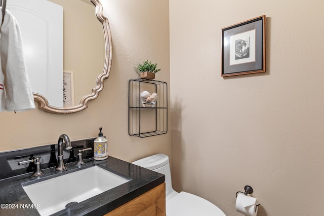 bathroom featuring toilet and vanity